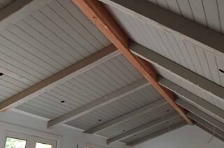 custom angled large gray wood tongue and groove (TNG) ceiling with beam